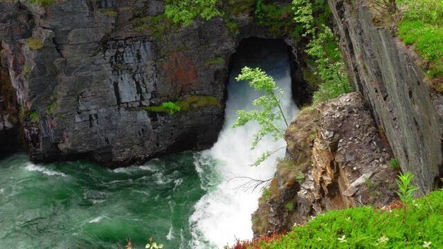 Abiskojokk waterfall running down the valley in Northen Sweden