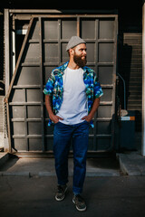 Young bearded hipster guy wearing white blank t-shirt. Mock-up for print. T-shirt template.