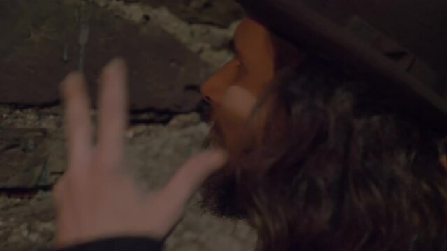 An stereotypic detetive / inspector observing a dark alley by night