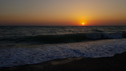 Beautiful sunset beach bright background with setting down sun in horizon