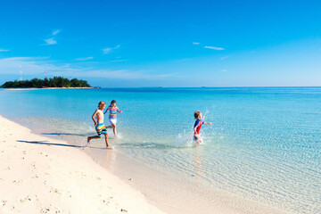 Kids playing on beach. Children play at sea.