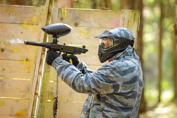 Fototapeta premium Close up of paintball player firing a marker