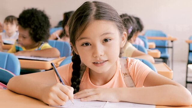 beautiful  little girl  studying in the classroom