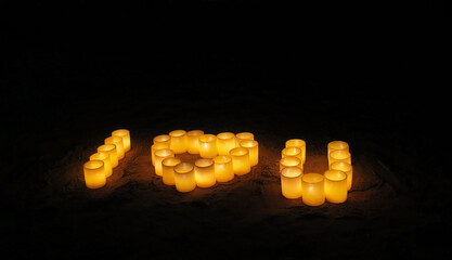 Romantic inscription from burning candles I love you on the beach