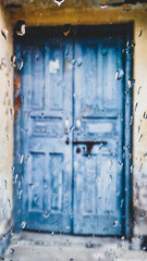 old blue door in the building with raindrops