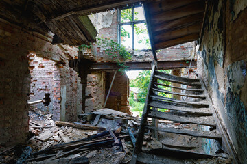 Depressing interior with stairs of an old burned down abandoned house