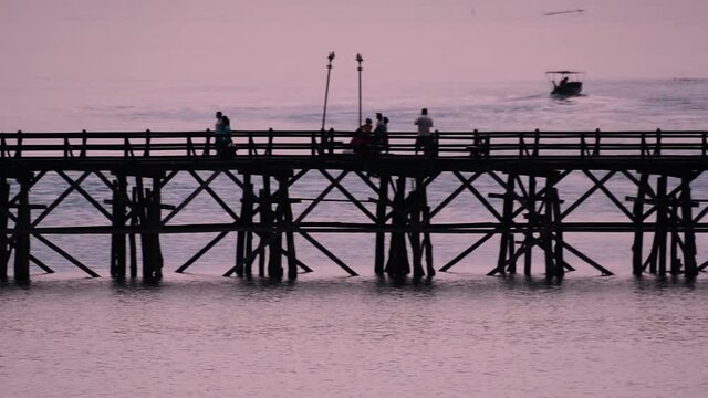 The Mon Bridge is an old wooden bridge located in Sangkla, Thailand. Monks and people cross before sunrise to earn merits and take blessings; in the afternoon, a leisure place to meet friends.