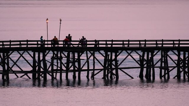 The Mon Bridge is an old wooden bridge located in Sangkla, Thailand. Monks and people cross before sunrise to earn merits and take blessings; in the afternoon, a leisure place to meet friends.