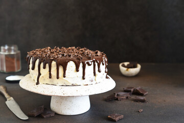 Chocolate truffle cake with cream cheese on a dark background.