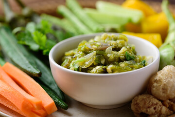Northern Thai food (Nam Prik Num), Spicy young green chili dip eating with boiled vegetables, fresh vegetables and pork rind, Local Thai food