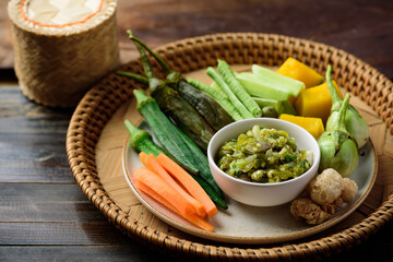Northern Thai food (Nam Prik Num), Spicy young green chili dip eating with boiled vegetables, fresh vegetables and pork rind, Local Thai food