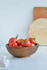 Fresh red tomatoes in a wooden bowl