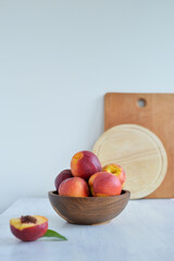 Peaches in a wooden bowl