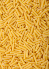 Fresh raw classic macaroni pasta ias texture background.