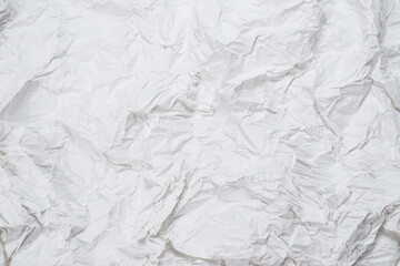 Crumpled white paper background.