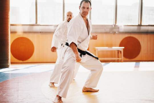 Senior karate master looks though on tatami