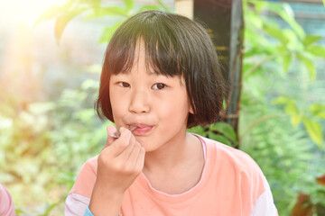 Close-up of Child girl hands holding spoon eating ice cream. Selective focus