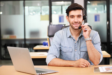 Fototapeta premium Caucasian businessman IT operator answering online phone call from customer as 24/7 customer service with copy space