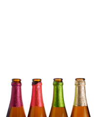 4 bottle necks are in a row, colored foil on the necks white background, isolated