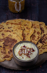 Kheer and besan puda, traditional punjabi foods served in traditional utensils