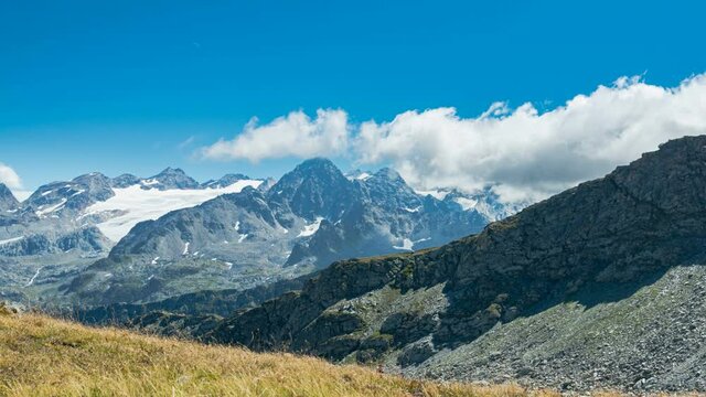 Panoraimic view of a glacier in Italian alps (called Rutor glacier, in Aosta Valley, Italy). Dramatic clouds moving in the blue sky. Time lapse