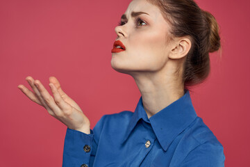 Portrait of emotional woman in blue shirt with bright makeup gesturing with hands Copy Space