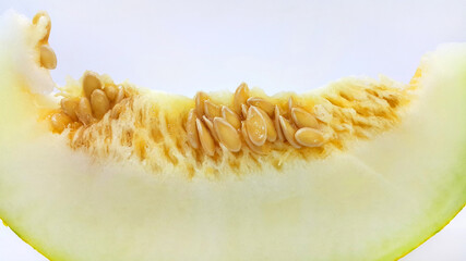 Naklejka premium Slice of ripe melon with seeds close-up on white background