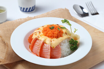 Salmon Lava Donburi. Salmon on a wooden cutting board, white background.