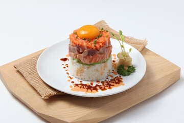 Salmon Lava Donburi. Salmon on a wooden cutting board, white background.