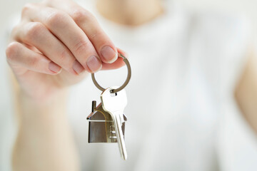 the key to your own home in the palm of the girl and a wooden house