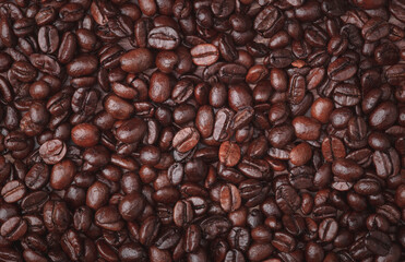 Roasted coffee beans close up macro shot for use texture background.