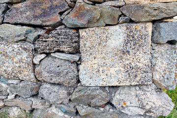 Stone tiles wall texture antique rock texture history construction archaeological exploration. Natural stone wall tiles texture. Old rock rustic textured stone pattern wallpaper surface.
