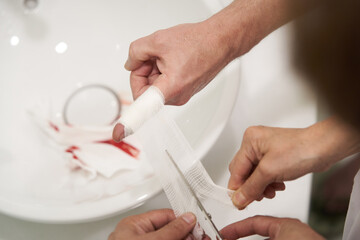 Bleeding blood from the cut finger, close-up.