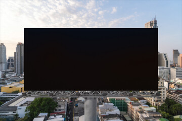 Obraz premium Blank black road billboard with Bangkok cityscape background at sunset. Street advertising poster, mock up, 3D rendering. Front view. The concept of marketing communication to promote or sell idea.