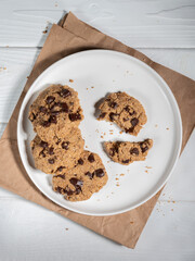 Cookies in white plate on white table. Flat lay.