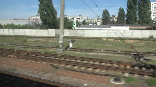 Kyiv region, Ukraine - 2nd of September 2020: 4K View on Ukrainian industrial zone from window of moving train
