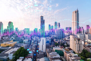 Market behavior graph hologram, sunset panoramic city view of Bangkok, popular location to achieve financial degree in Asia. The concept of financial data analysis. Double exposure.