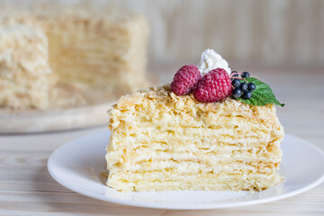 Piece of napoleon cake. Creamy vanilla slice dessert on plate. Delicious pastry served with...