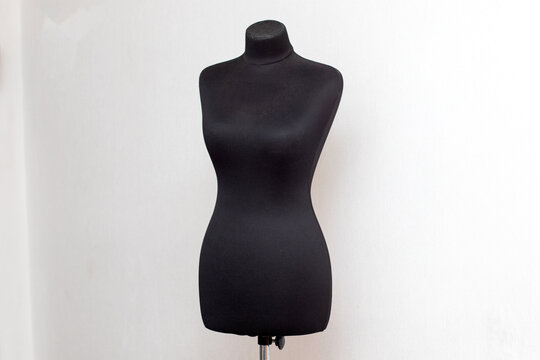 Professional black women tailor sewing mannequin