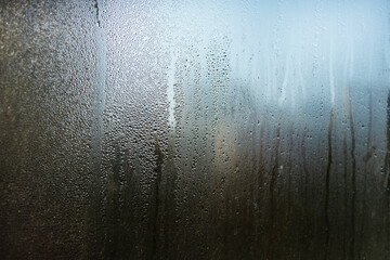  Misted window glass. Drops and trickles of water.