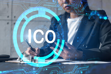 Businesswoman taking notes and ICO hologram. Double exposure. Business technology initial coin...