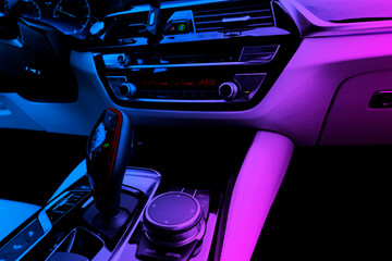 Modern luxury car white leather interior with in blue and pink tones. Part of leather car seat...