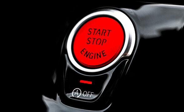 Car dashboard with focus on red engine start stop button. Modern car interior details. start/stop button. Car inside. Ignition remote starter