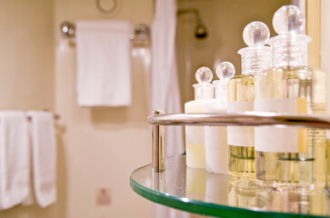 Bathroom amenities in marble bathroom of suite stateroom or cabin with shampoo, conditioner, shower...