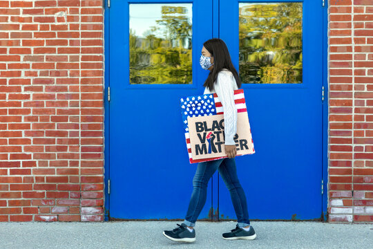 Female Taiwanese BLM Protestor Walking With Protest BLM And American Flag Signs In 