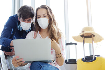 ํYoung Caucasian traveler couple love wear mask for prevention for covid-19 virus is relaxing...