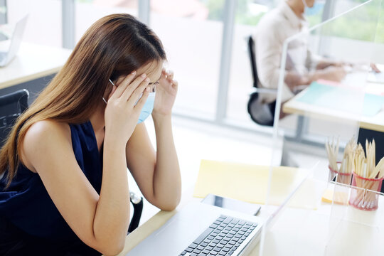 Young Asian Businesswoman Wearing Mask Preventing For Covid 19 Virus And Have A Headache And Feel Sickness In Office. Social Distance And New Normal Lifestyle Concept