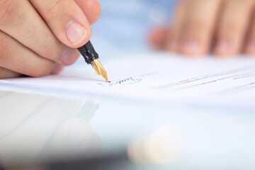 Businessman signs a contract, business contract details