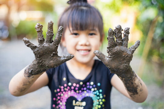 Kids playing with clay muddy. This activity is good for sensory experience and learning by touch their hands and fingers through clay and enjoying its texture.