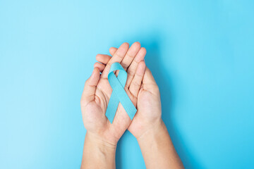 November Prostate Cancer Awareness month, Man holding light Blue Ribbon for supporting people living and illness. Healthcare, International men, Father, World cancer day and world diabetes day concept